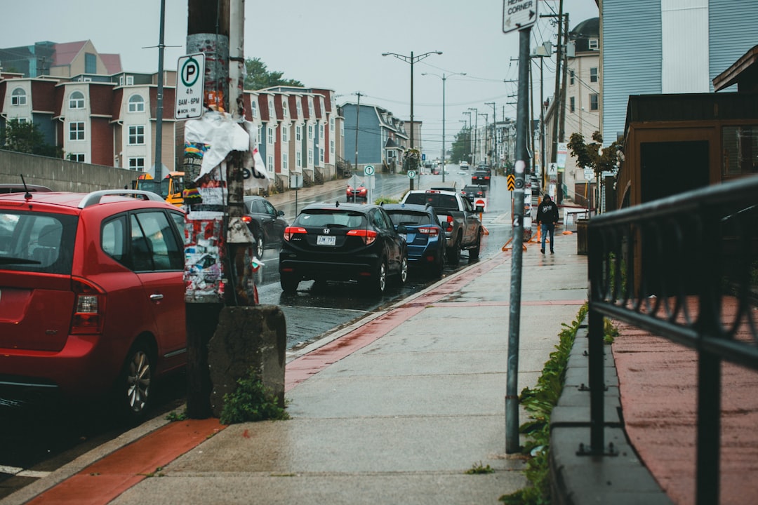 red car on the street during daytime