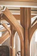 Elegant wooden ceiling beams adding warmth to a spacious room.