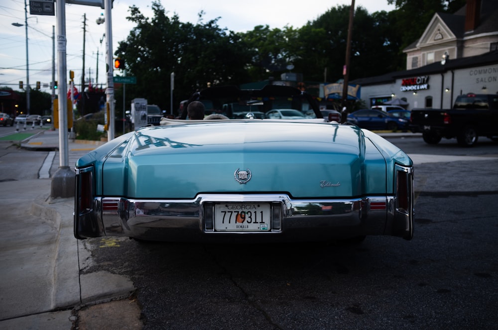 green convertible car parked on the side of the road