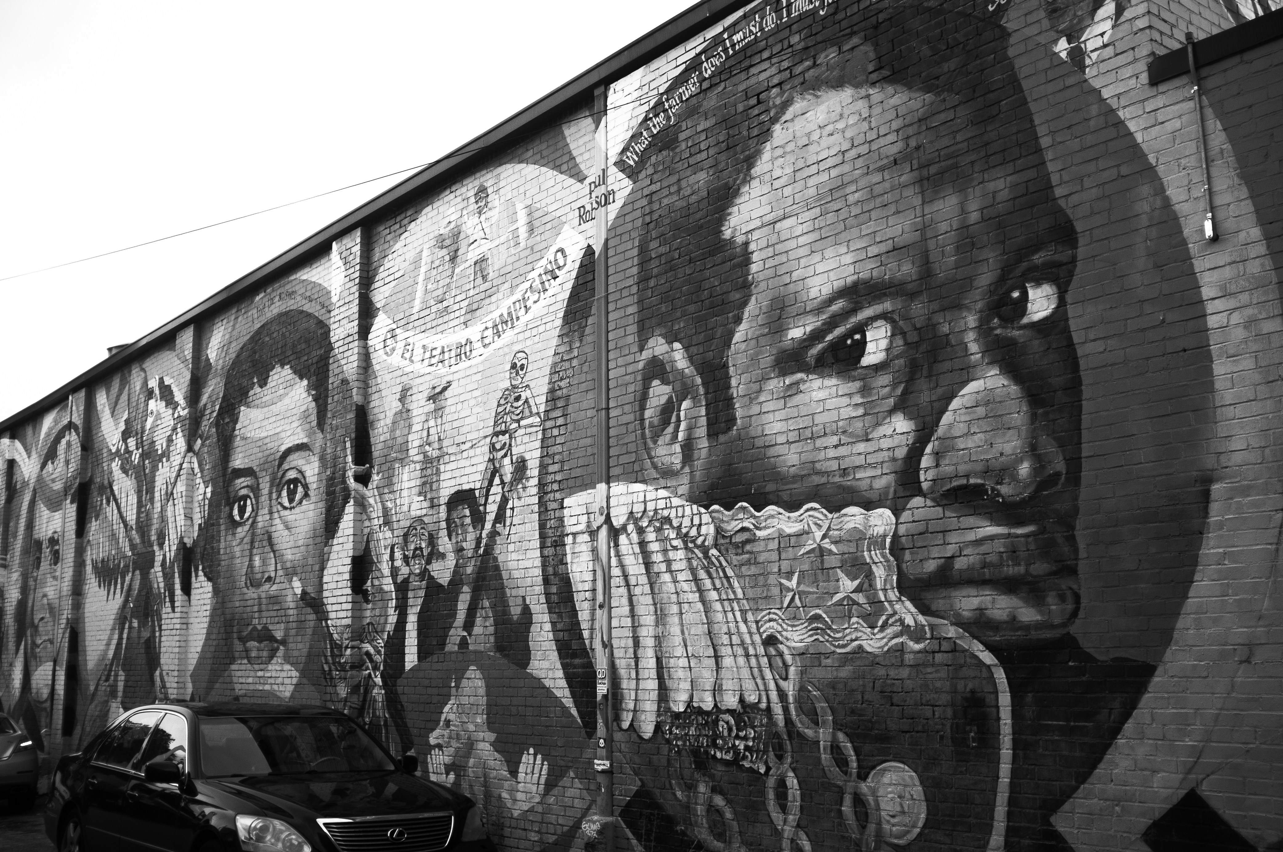 grayscale photo of man and woman with face graffiti