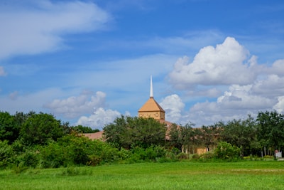 A serene image of a church building surrounded by nature, symbolizing peace and community.