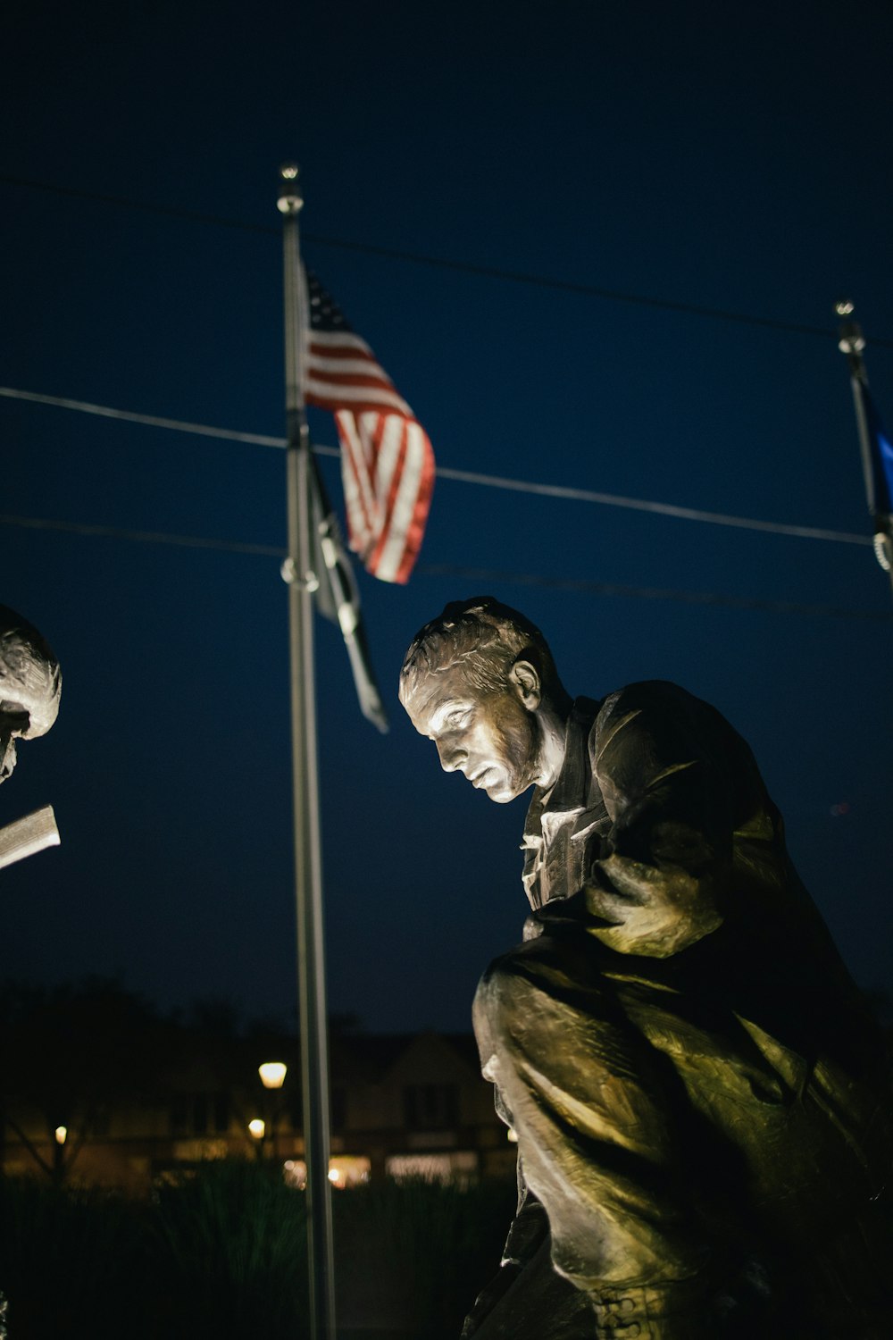 man in black jacket holding flag of us a during night time