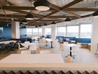 Workers enjoying a bright, clean industrial dining area with comfortable seating.