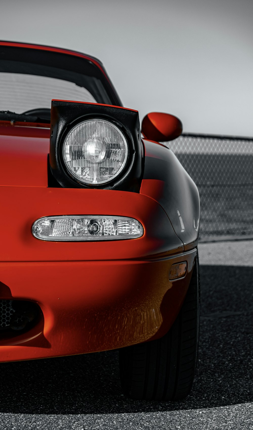 red car on gray asphalt road during daytime