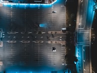 Night view of a parking lot illuminated with security cameras capturing clear footage.