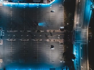 Night view of a parking lot illuminated with security cameras capturing clear footage.