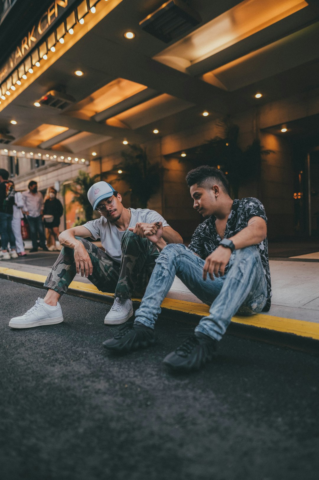 man in blue denim jacket sitting on floor