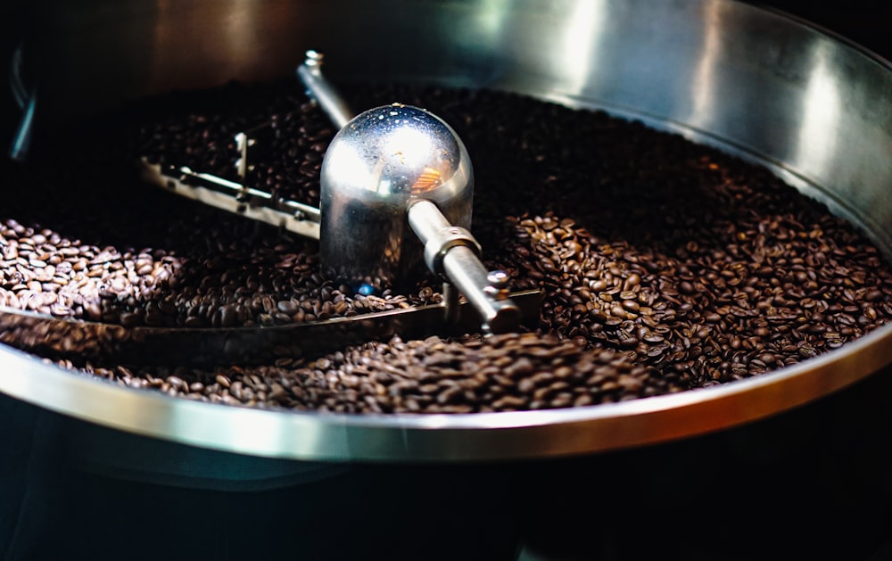 black and brown coffee beans on round stainless steel bowl