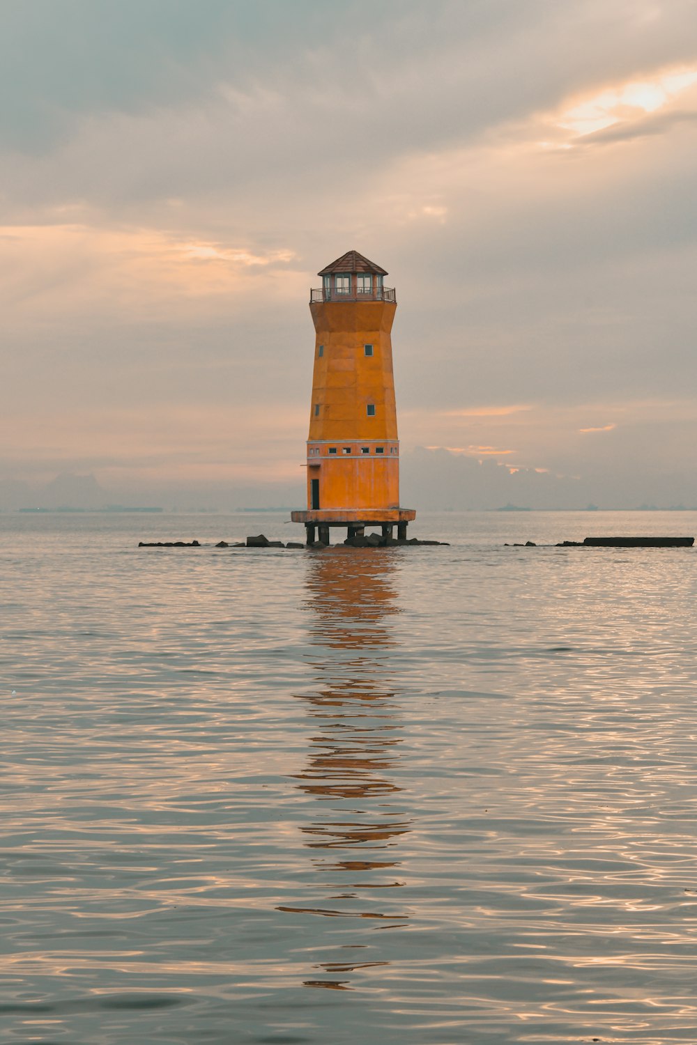 red and white lighthouse on sea during daytime