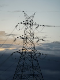 black electric post under cloudy sky during daytime