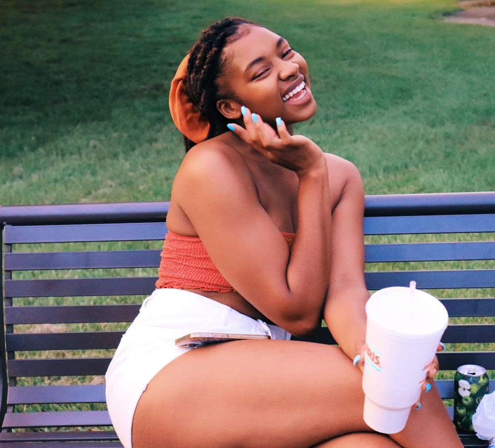 woman in white shorts sitting on bench