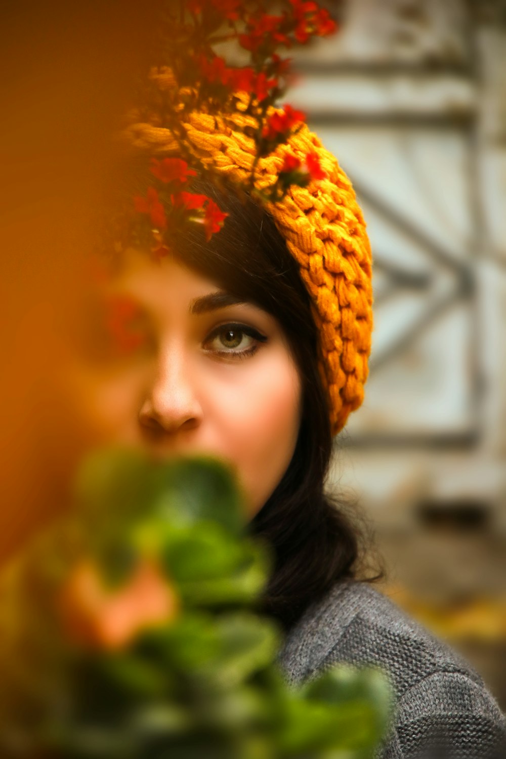 woman in gray knit sweater and orange knit cap