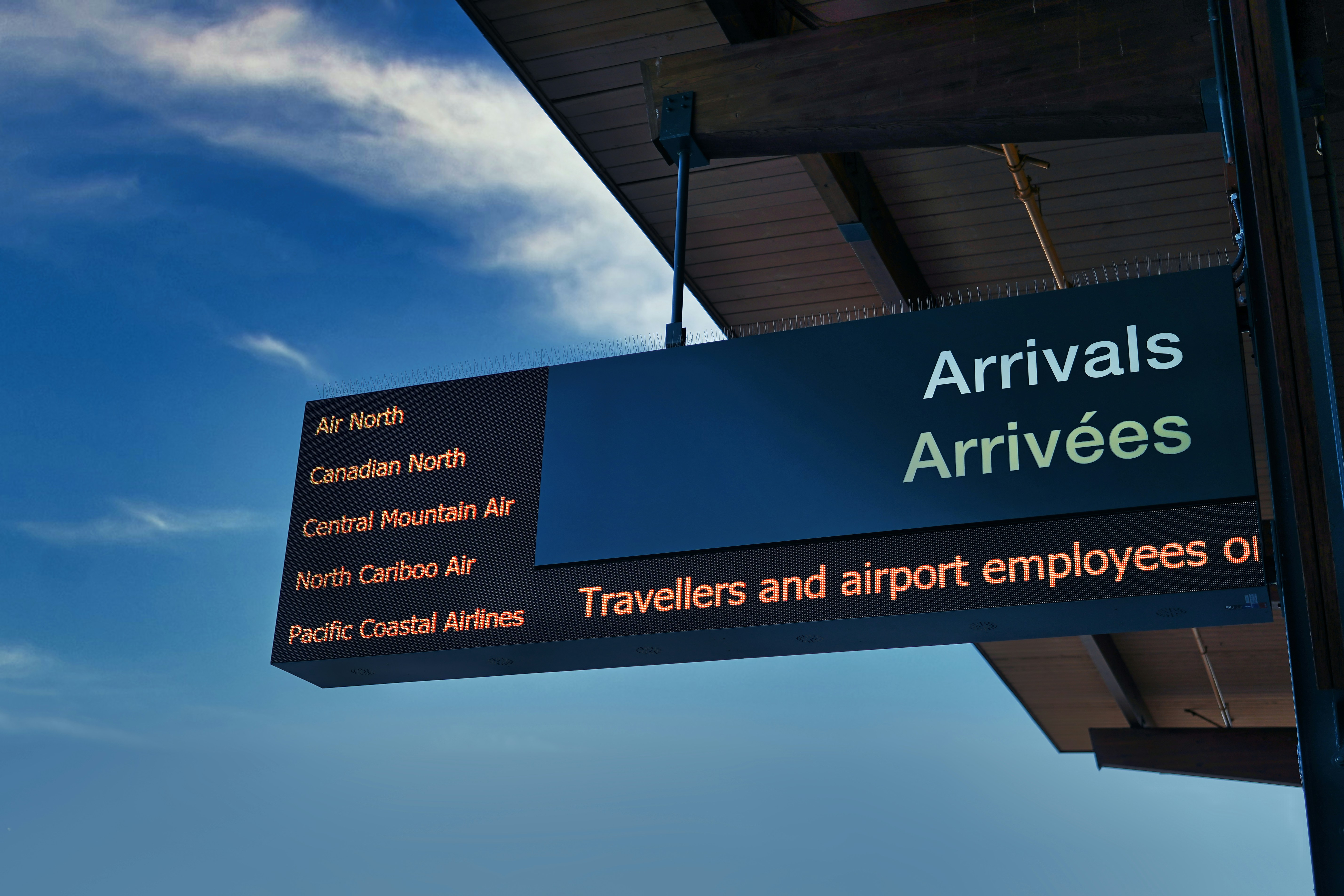 a sign hanging from the side of a building, 