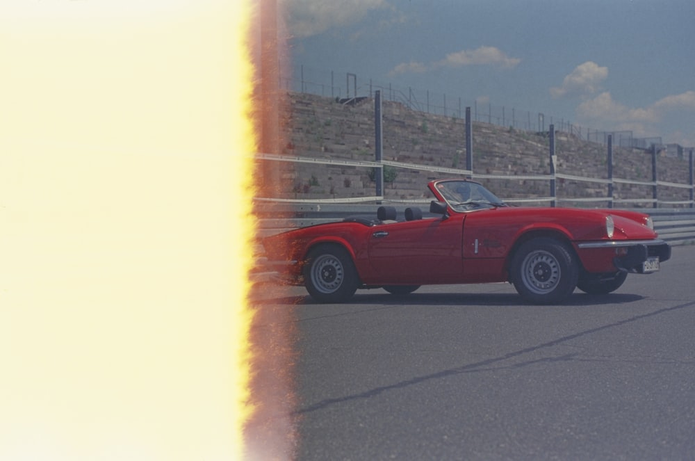 red chevrolet camaro on road during daytime