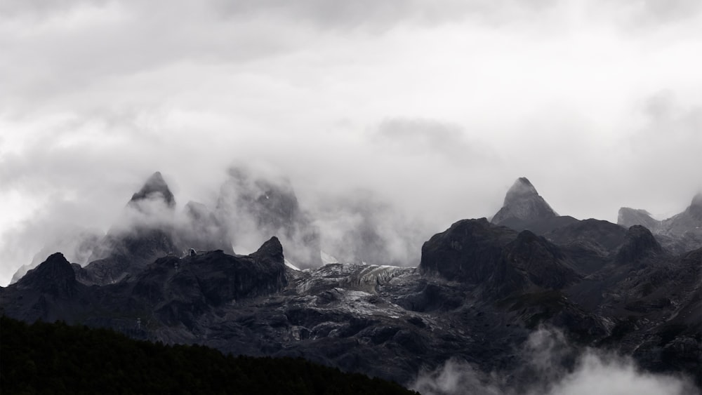 black and white mountain under white clouds