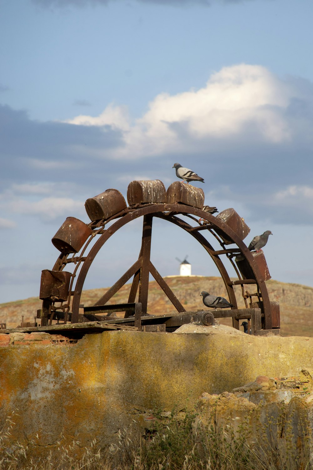 brown wooden wheel on brown field during daytime