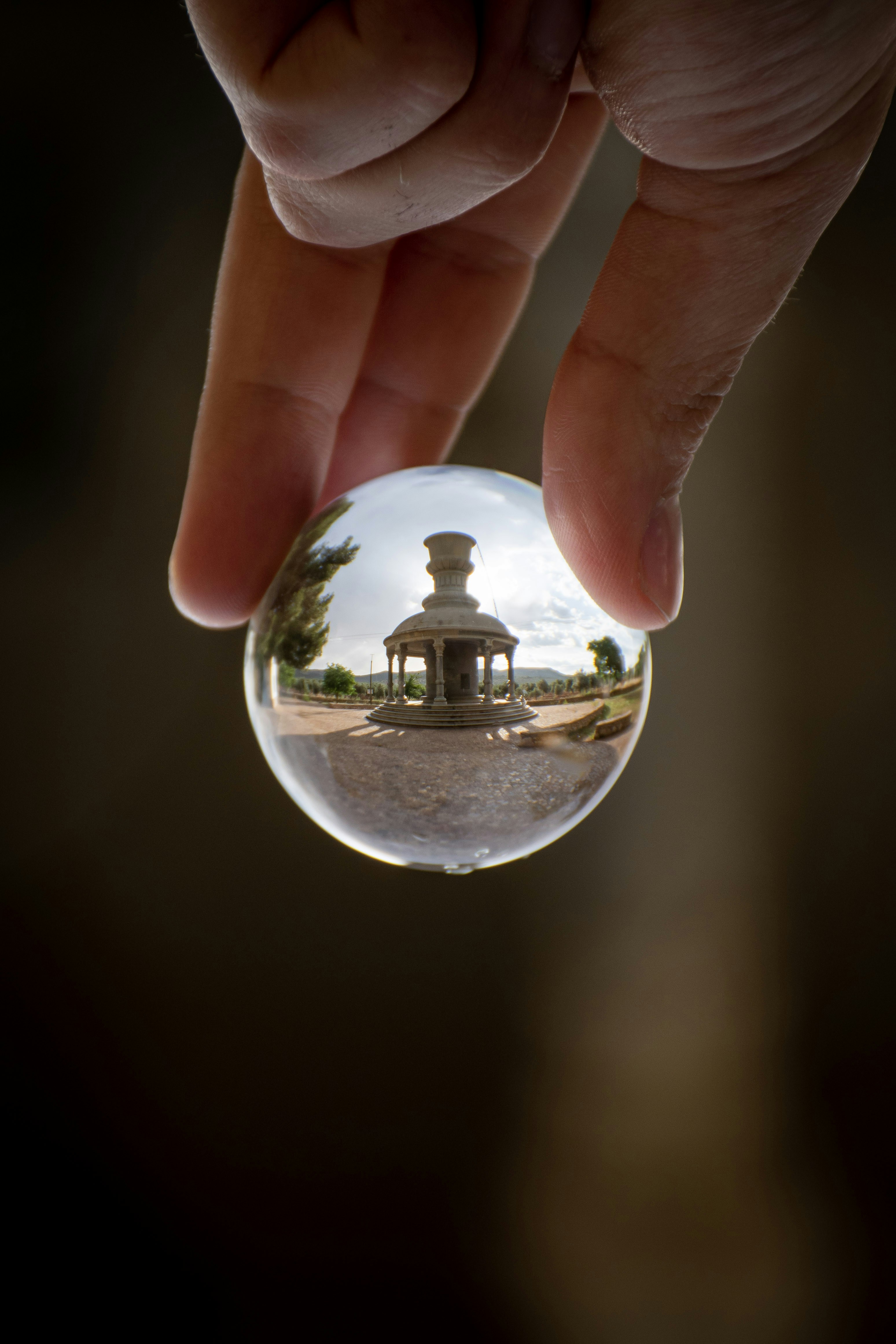 person holding clear glass ball