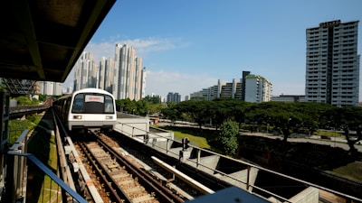 white train on rail during daytime