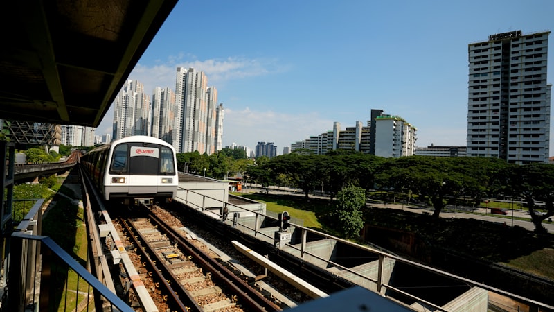 A Singapore MRT train with the skyline behind