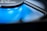 A close-up of a sleek, portable mini fan on a gym mat.