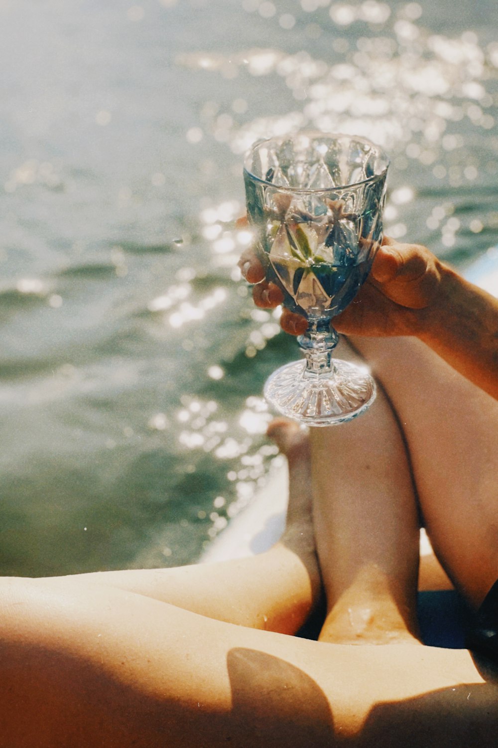 person holding blue and clear glass cup