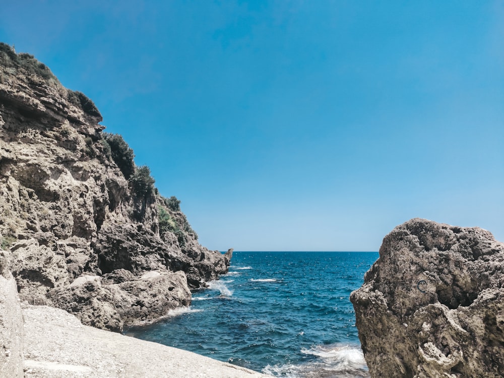 a view of the ocean from a rocky cliff