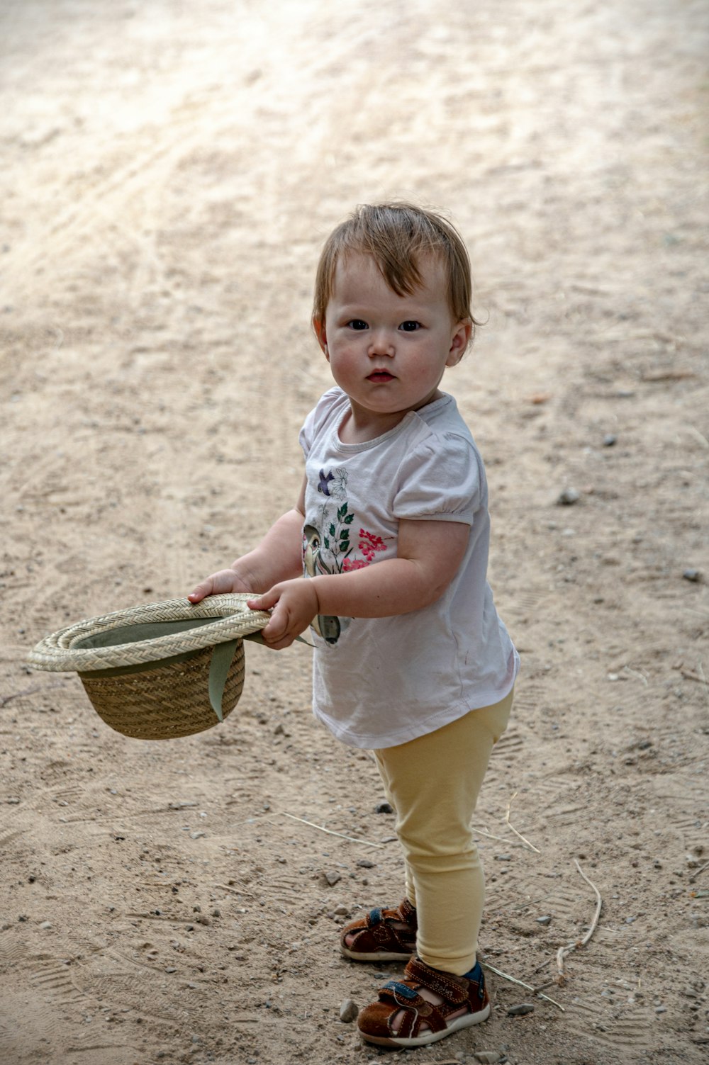 boy in red and white crew neck t-shirt holding brown wooden basket