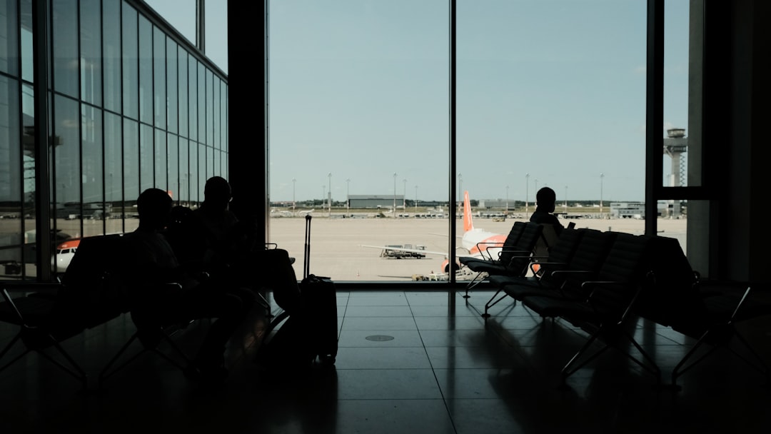 silhouette of man sitting on chair near window