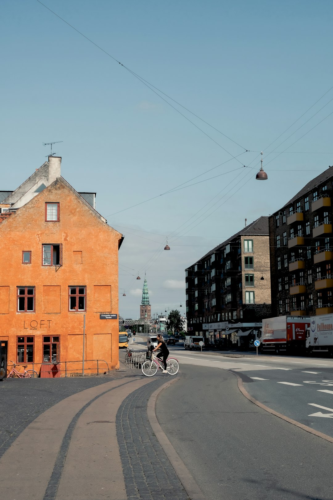 people riding bicycle on road near brown concrete building during daytime