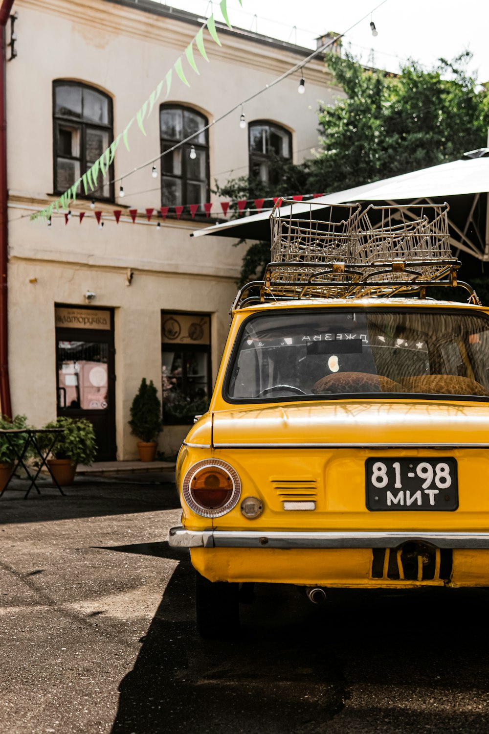 yellow and white volkswagen t-2 parked beside building during daytime