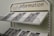 A display rack filled with informational brochures is seen. The brochures have a blue and white color scheme and feature text with QR codes. Above the rack, a sign reads 'info information' in uppercase and lowercase letters.