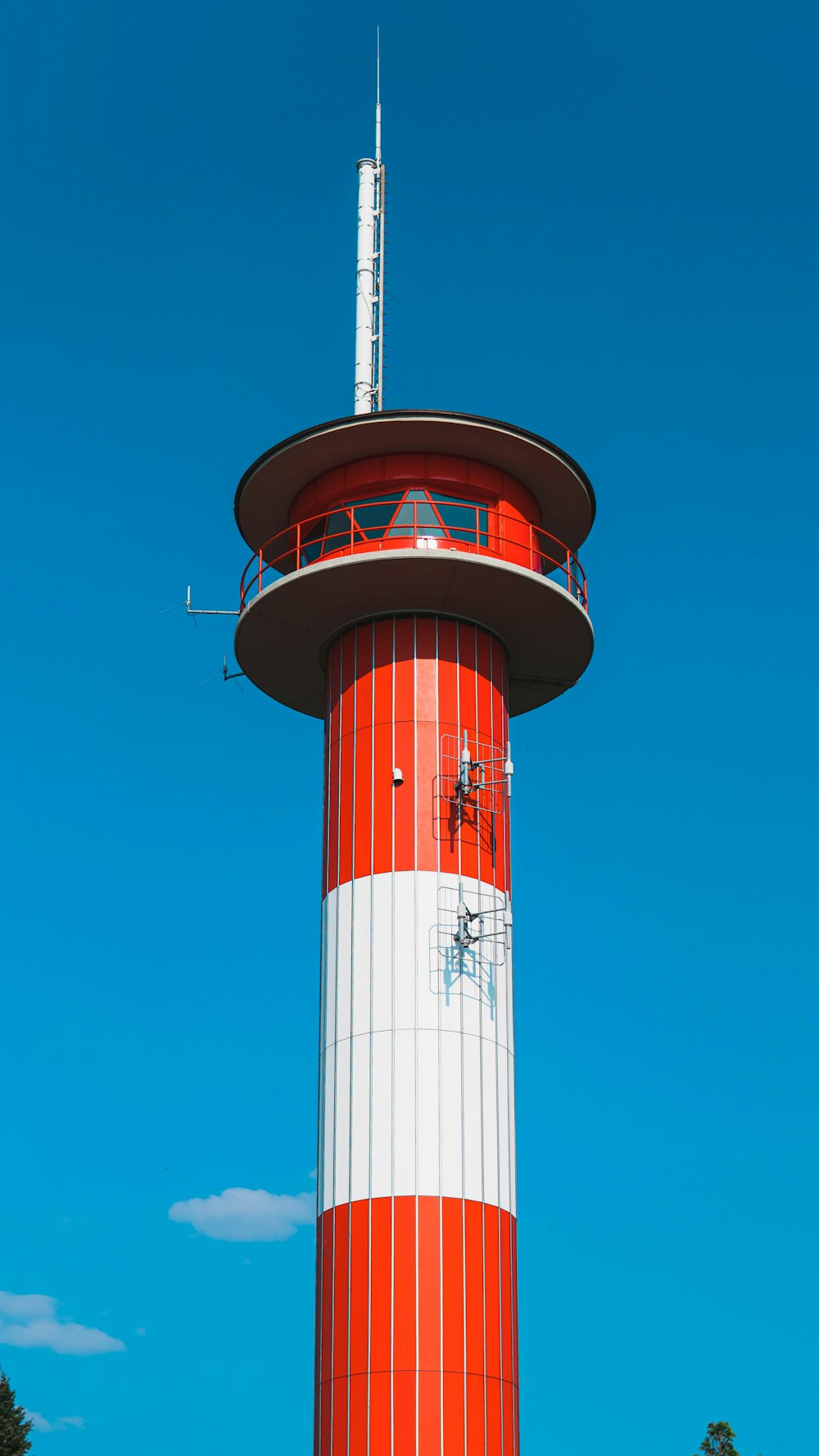 white and red tower under blue sky during daytime