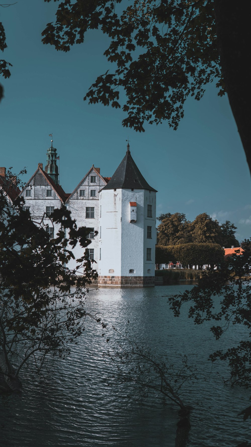 white and brown concrete building near body of water during daytime