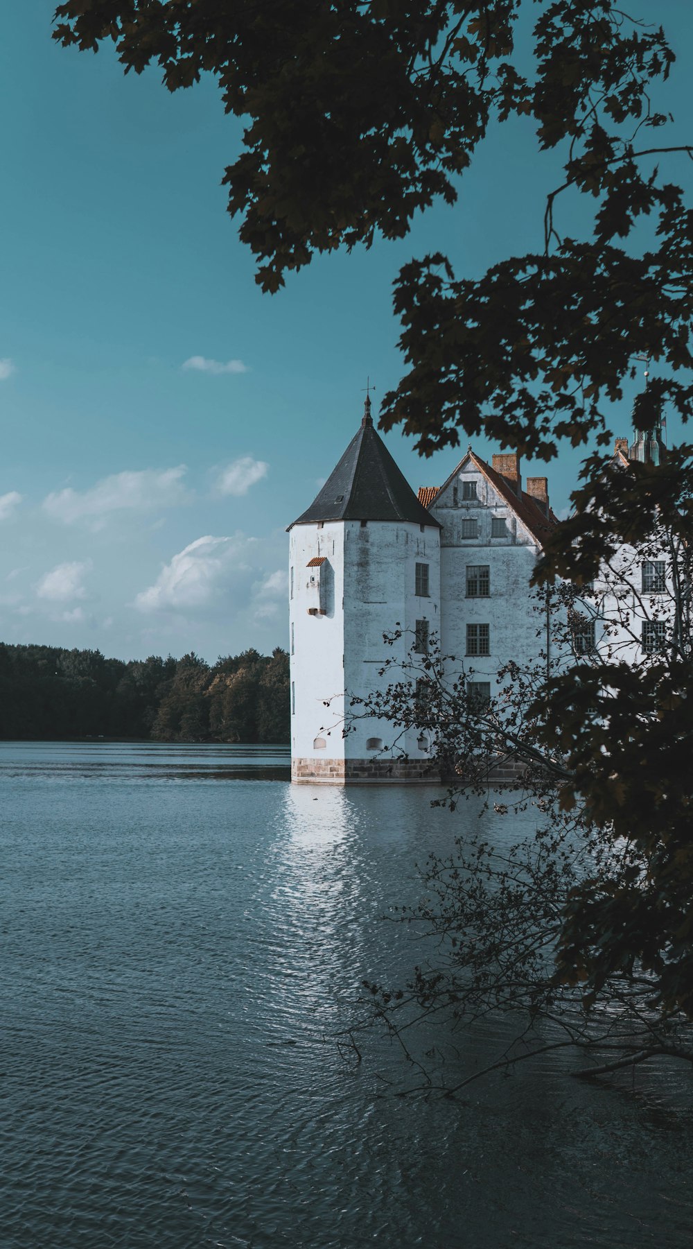 white and brown concrete building near body of water during daytime