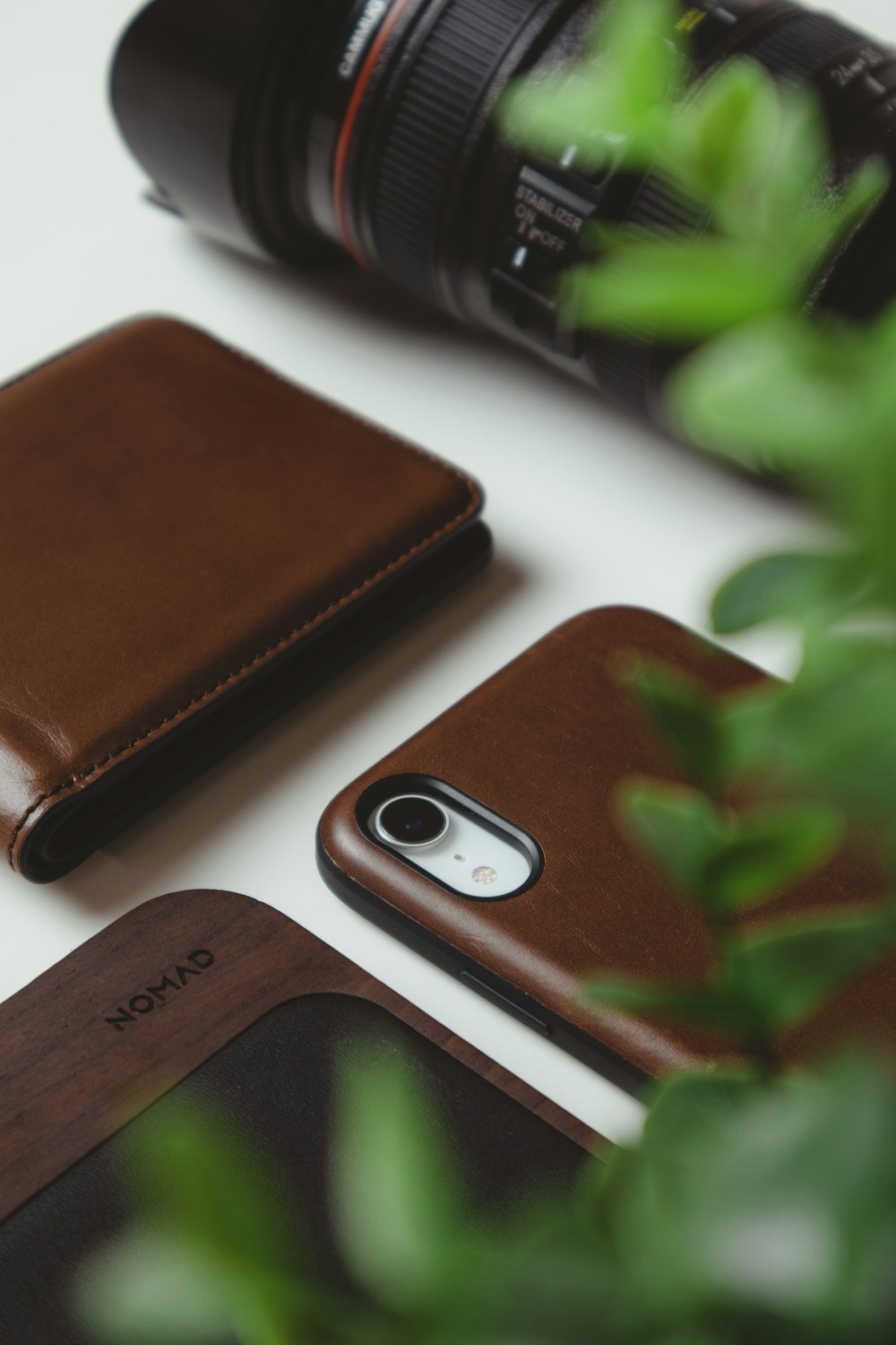 silver iphone 6 beside brown leather bifold wallet