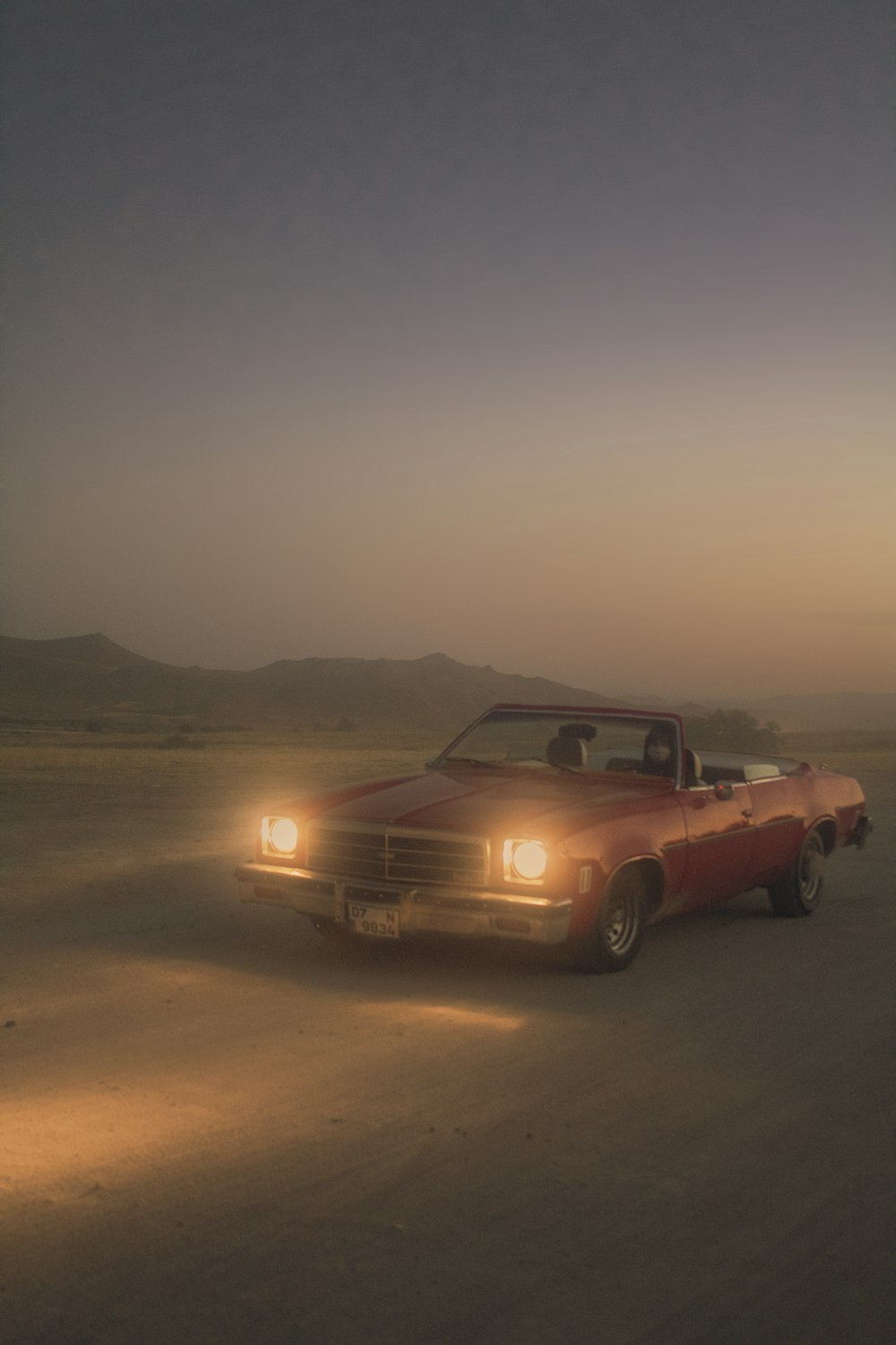 brown chevrolet camaro on desert during sunset