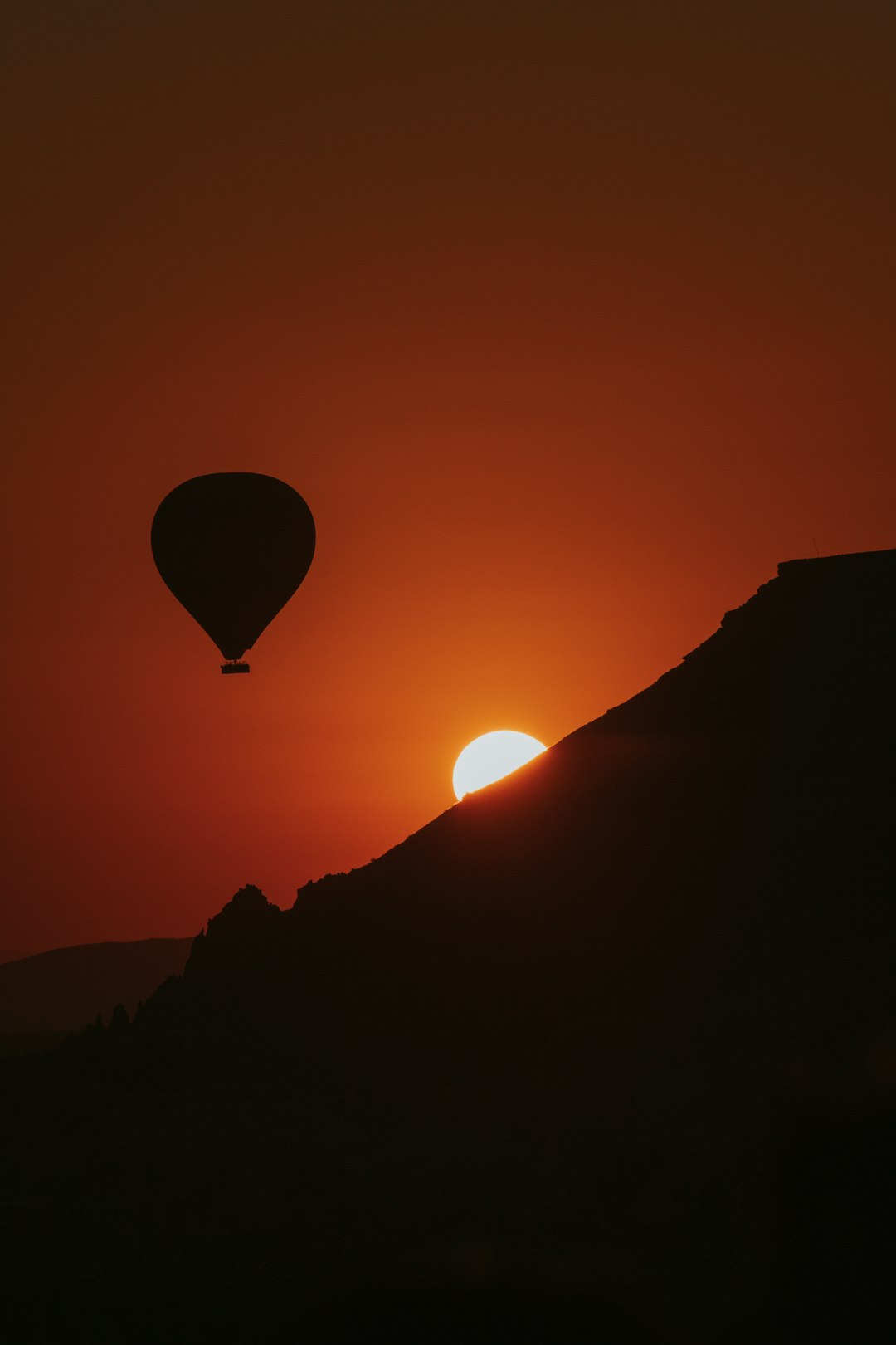silhouette of hot air balloon during sunset