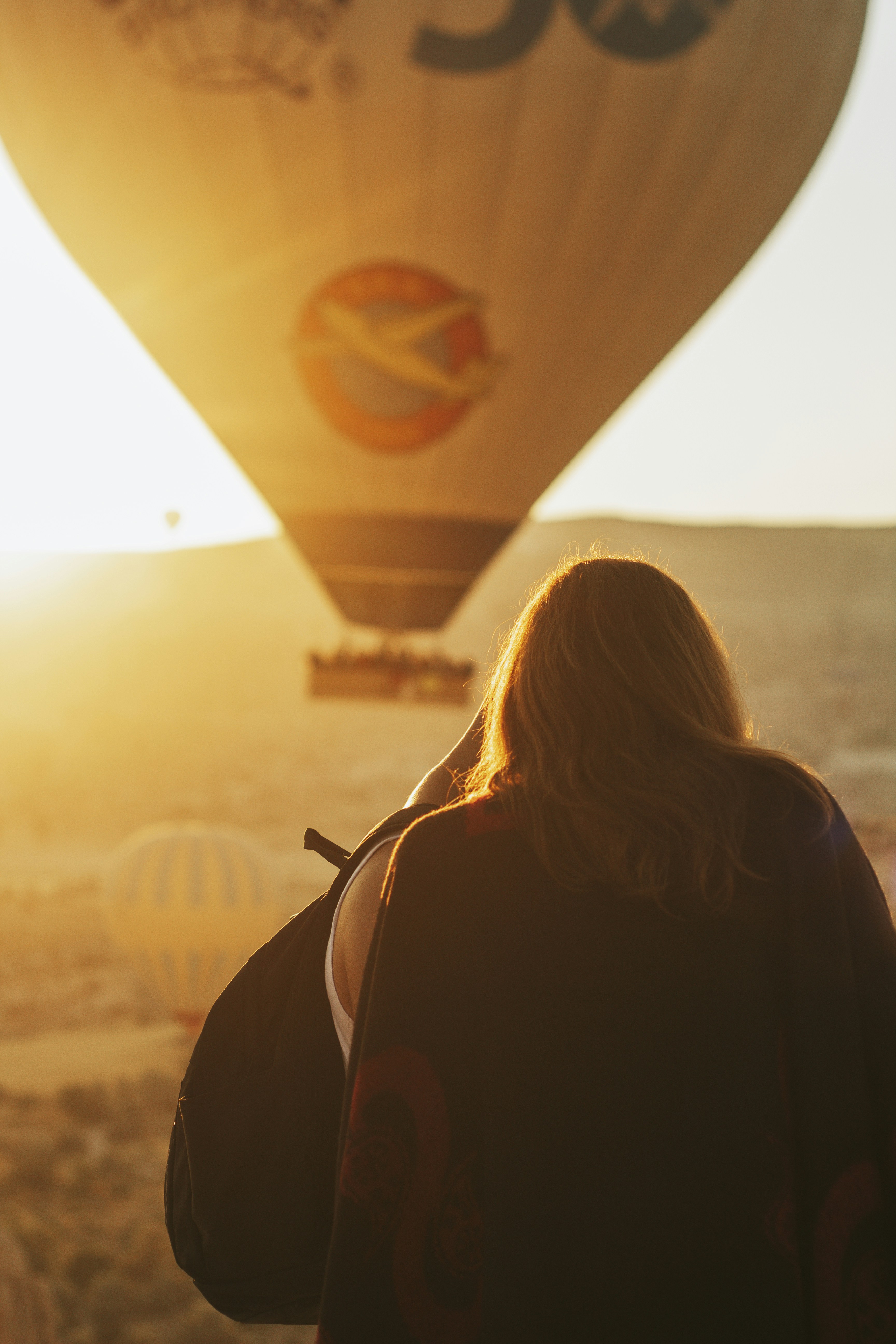 woman in black long sleeve shirt looking at the sun