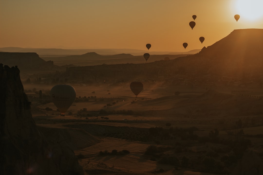 hot air balloons flying over the mountains during daytime