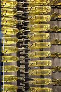 clear glass bottles on black metal rack