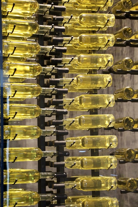 clear glass bottles on black metal rack