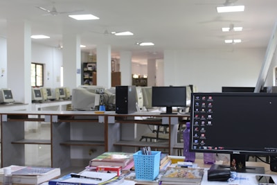 black flat screen computer monitor on brown wooden desk