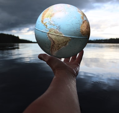 person holding clear glass ball