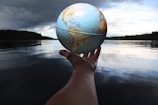person holding clear glass ball