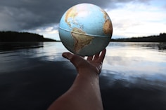 person holding clear glass ball