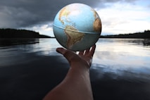 person holding the world of aquaculture opportunities