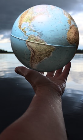 person holding clear glass ball