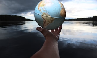 person holding clear glass ball