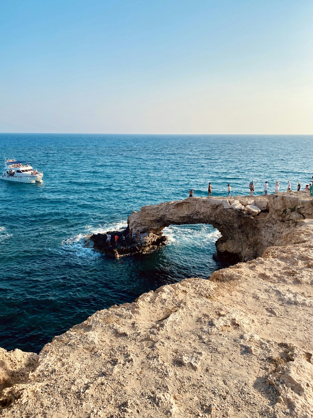 white and blue boat on sea during daytime