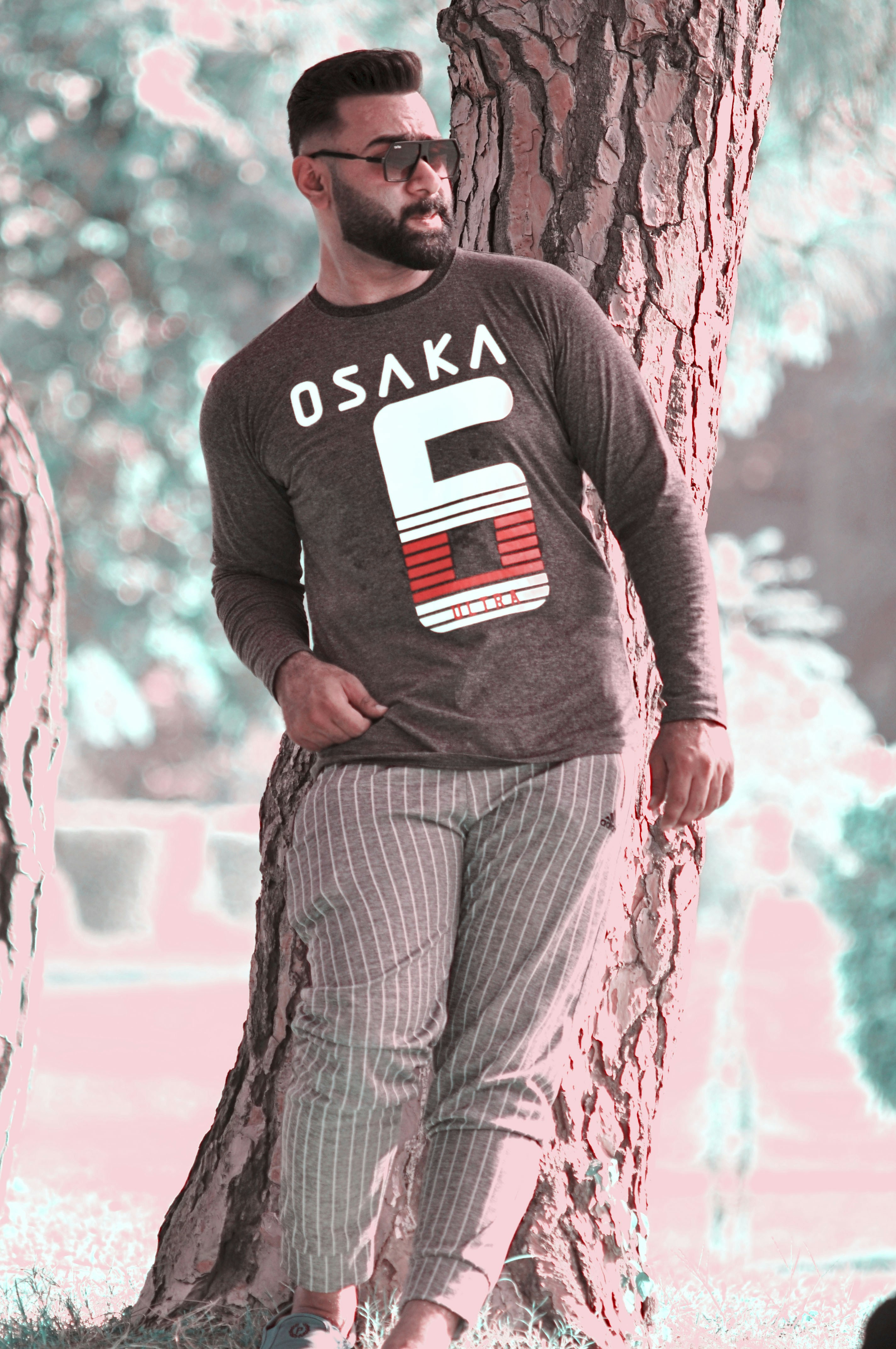 man in black and white crew neck long sleeve shirt standing